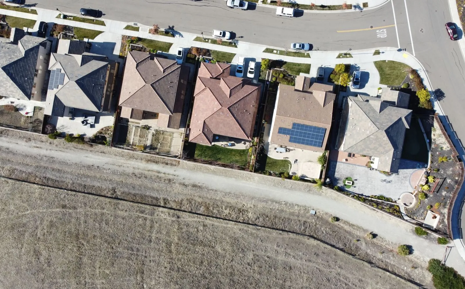 Overhead view of a California suburban neighborhood with solar panels on several rooftops