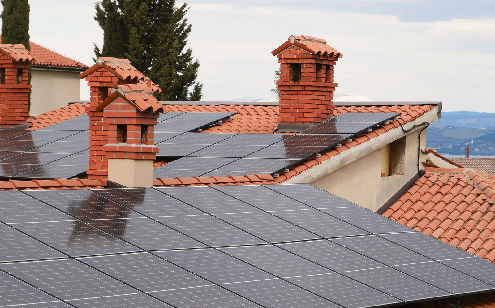 Solar panels covering tiled roofs in a residential neighborhood