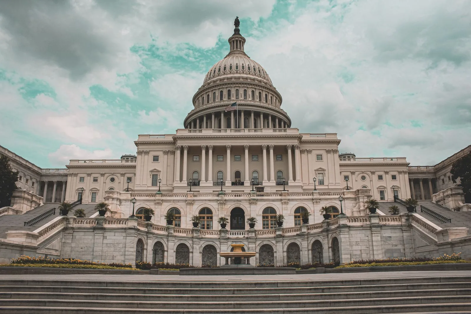 The United States Capitol building under a heavy cloudy sky